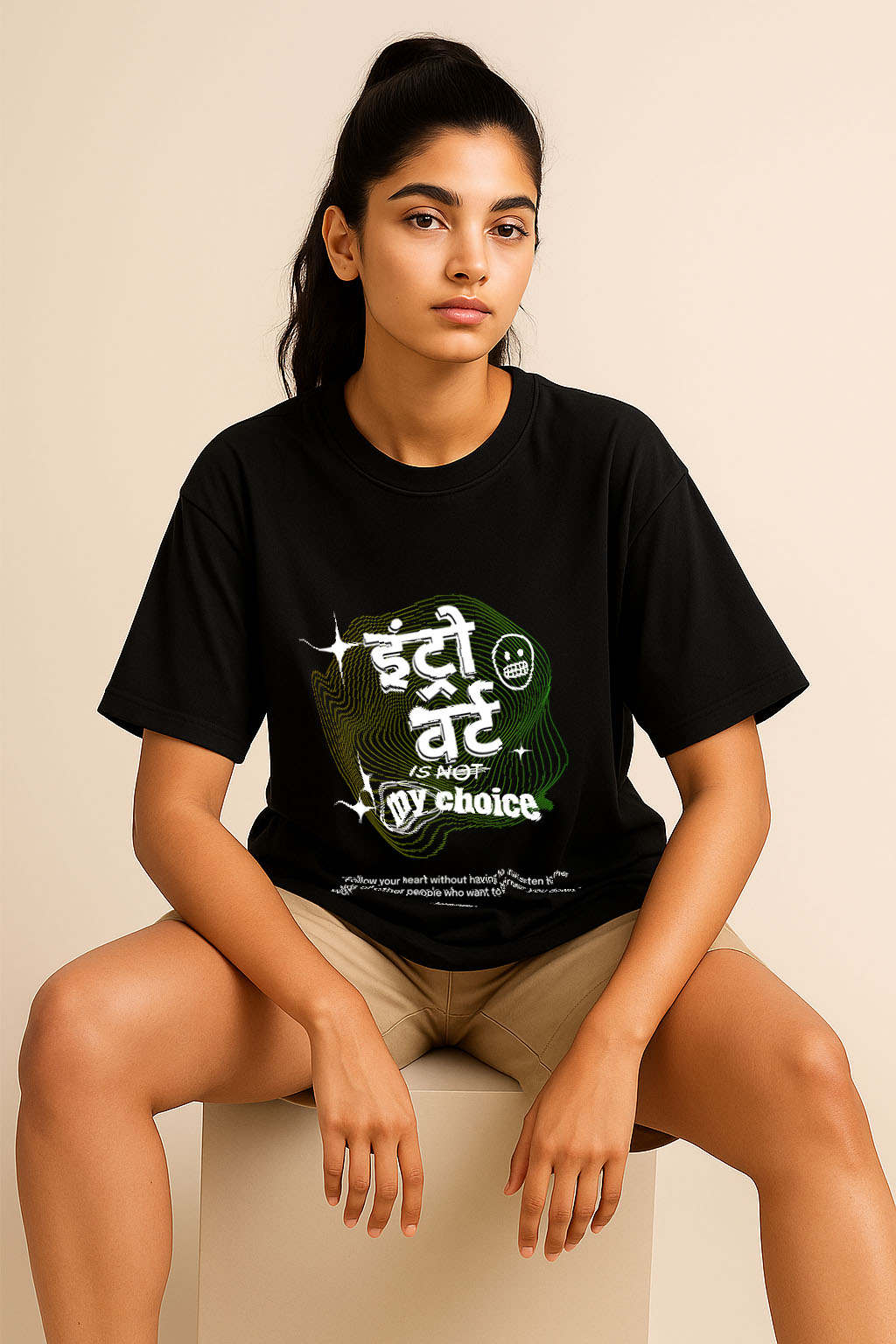 Oversized introvert t-shirt for women in black – seated look highlighting neon Hindi quote design