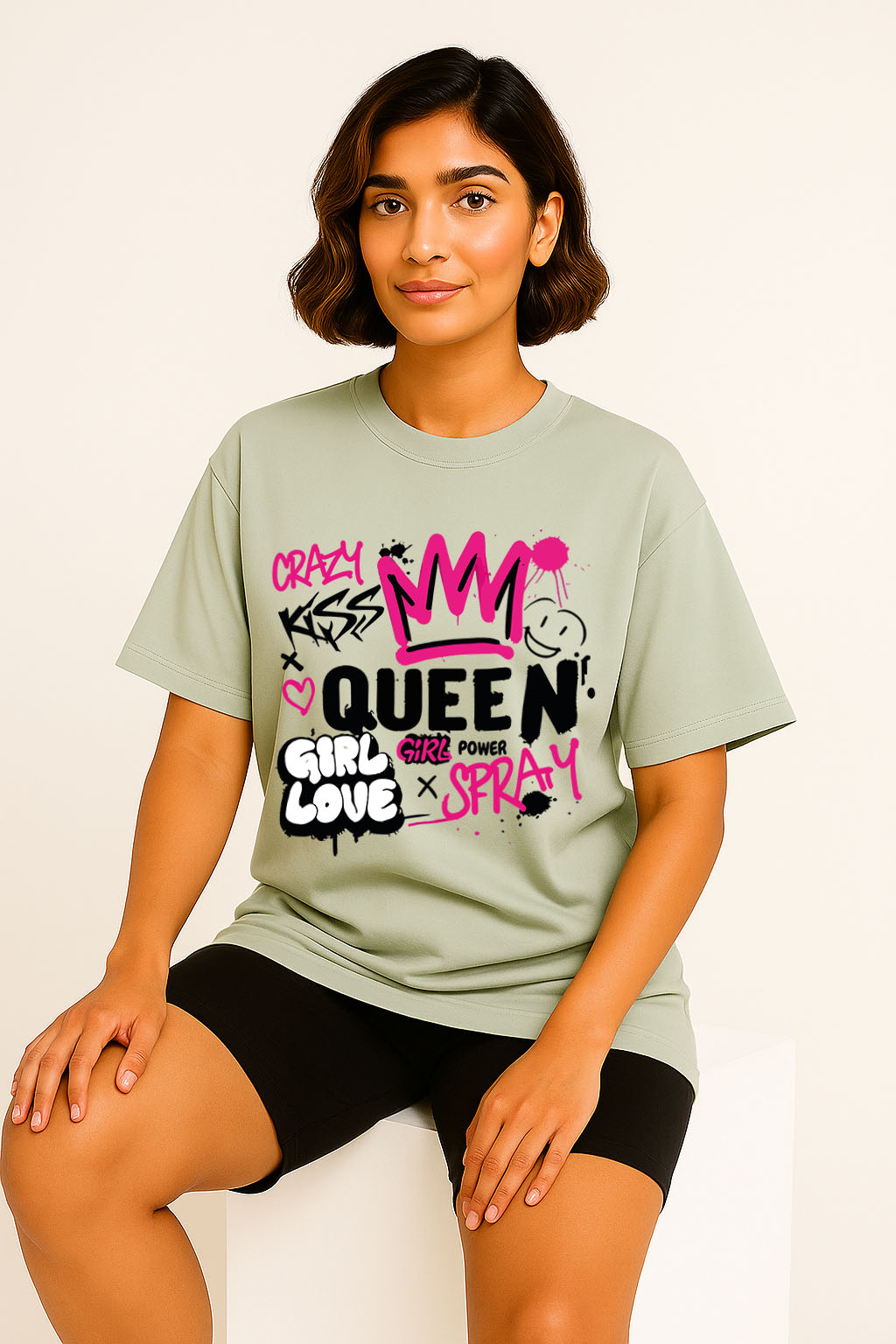 Sitting pose featuring women's oversized grey t-shirt with urban graffiti print – girl power aesthetic