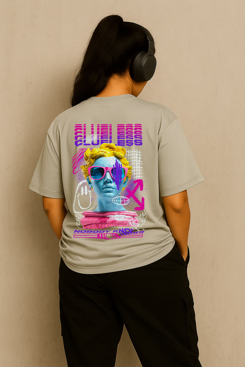 Back view of grey oversized t-shirt for women with neon grunge design – urban streetwear style