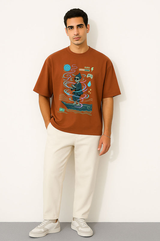 Man wearing a brown oversized aura farming graphic t-shirt and white pants against a white background