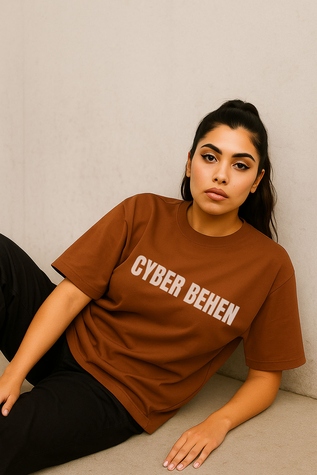 Chill pose of model in brown Hindi graphic oversized t-shirt for women – Cyber Behen by BANKAZ