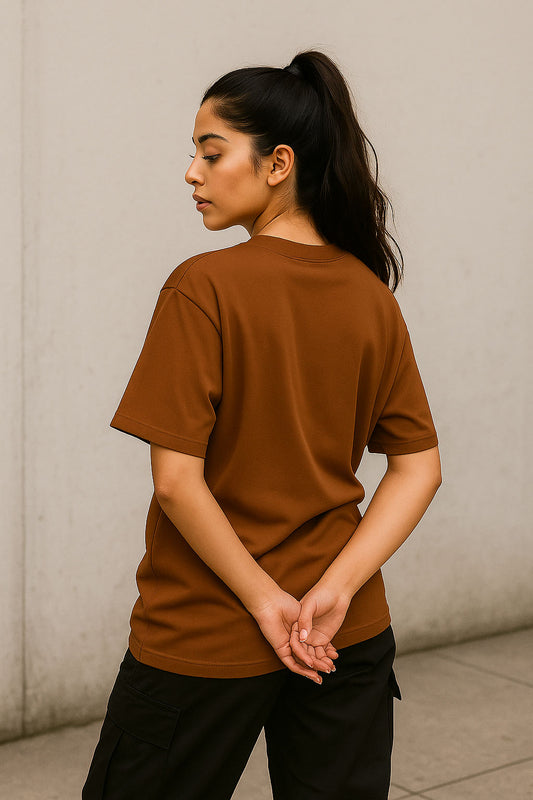 Back view of brown oversized anime solitude t-shirt for women with minimal streetwear aesthetic