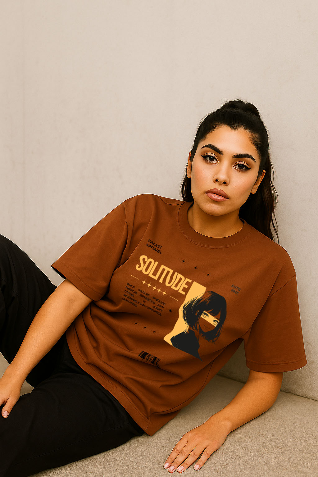 Model seated wearing brown solitude anime oversized t-shirt for women – aesthetic graphic print