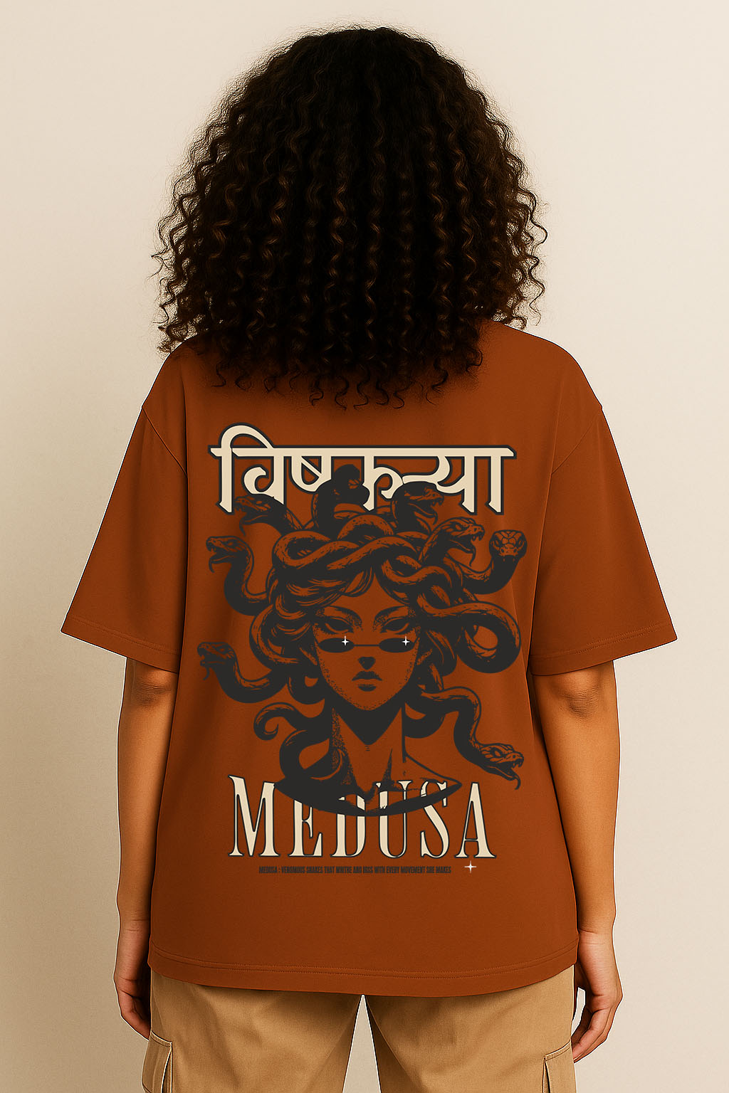 Back view of brown oversized desi Medusa t-shirt for women featuring bold graphic Hindi streetwear design