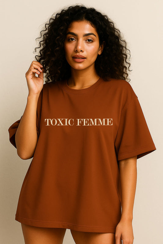 Front view of brown oversized t-shirt for women with "Toxic Femme" minimal typography design