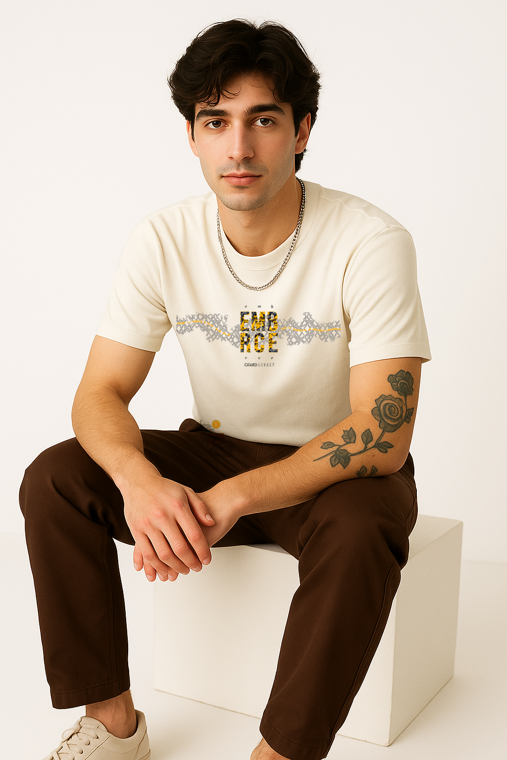 Embrace Legacy white cotton t-shirt for men – stylish seated pose highlighting chest design