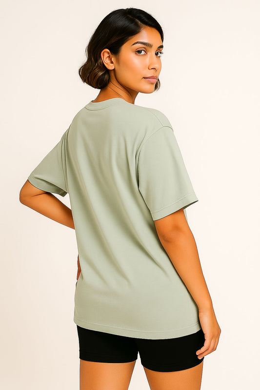 Back view of grey oversized t-shirt for women featuring bold graffiti-style girl power artwork – trendy streetwear look