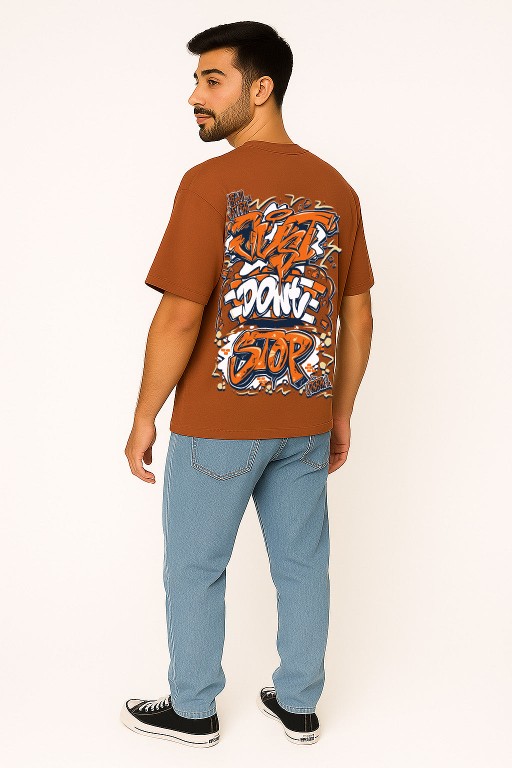 Back of brown oversized t shirt featuring colorful graffiti t shirt design and brick wall art styling