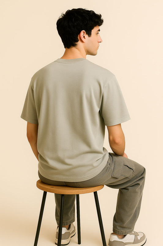 Side-back angle of BANKAZ grey oversized grunge t shirt with simple plain design