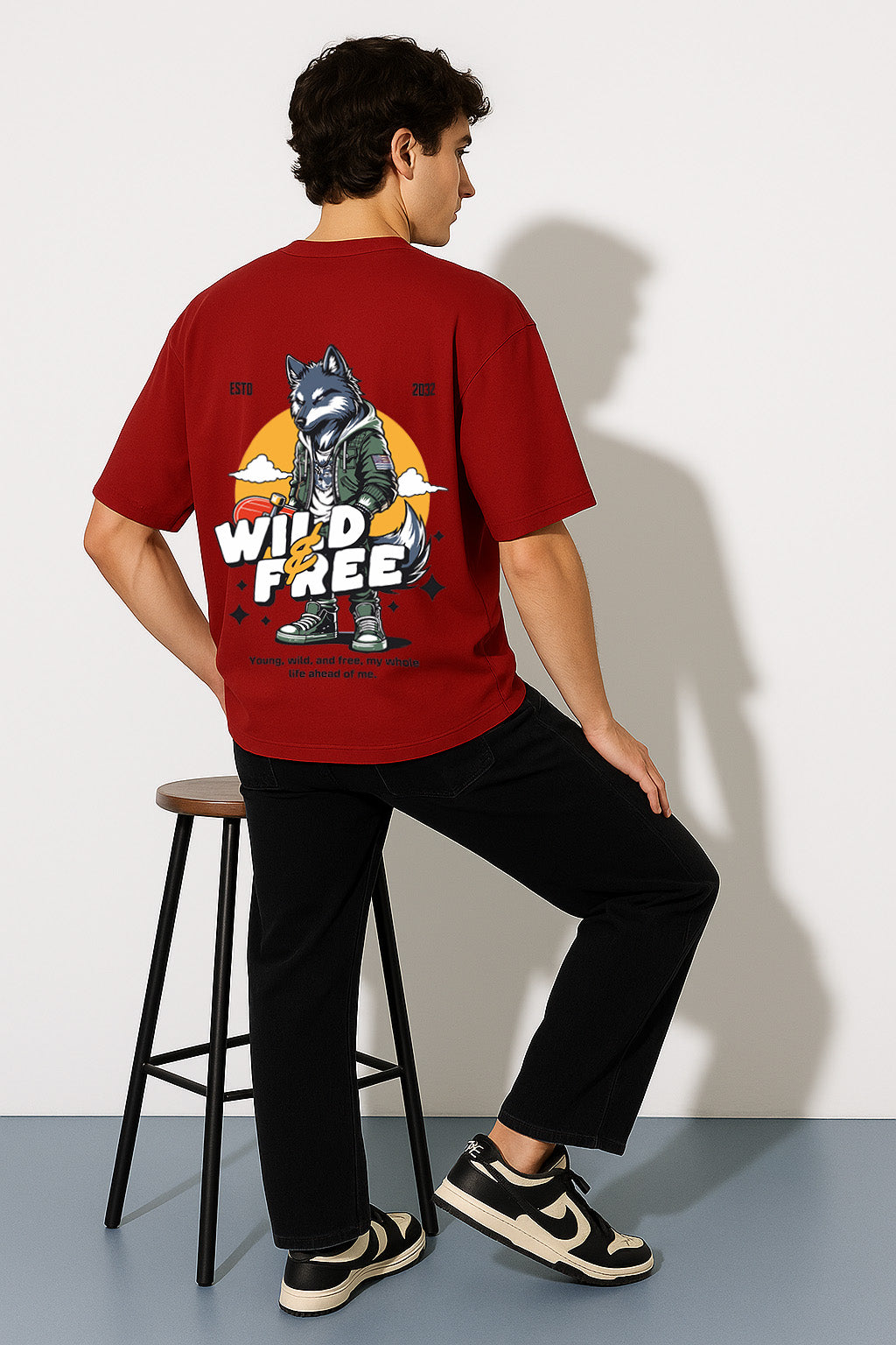 Lone wolf t shirt in red oversized fit showing detailed back graphic with wolf and wild & free quote
