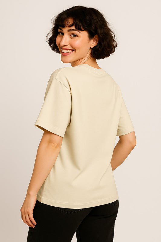 Back view of off-white cotton oversized graffiti t-shirt for women featuring street-style green spray-paint print