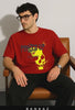 guy standing from chair wearing bankaz red skull printed oversized t-shirt