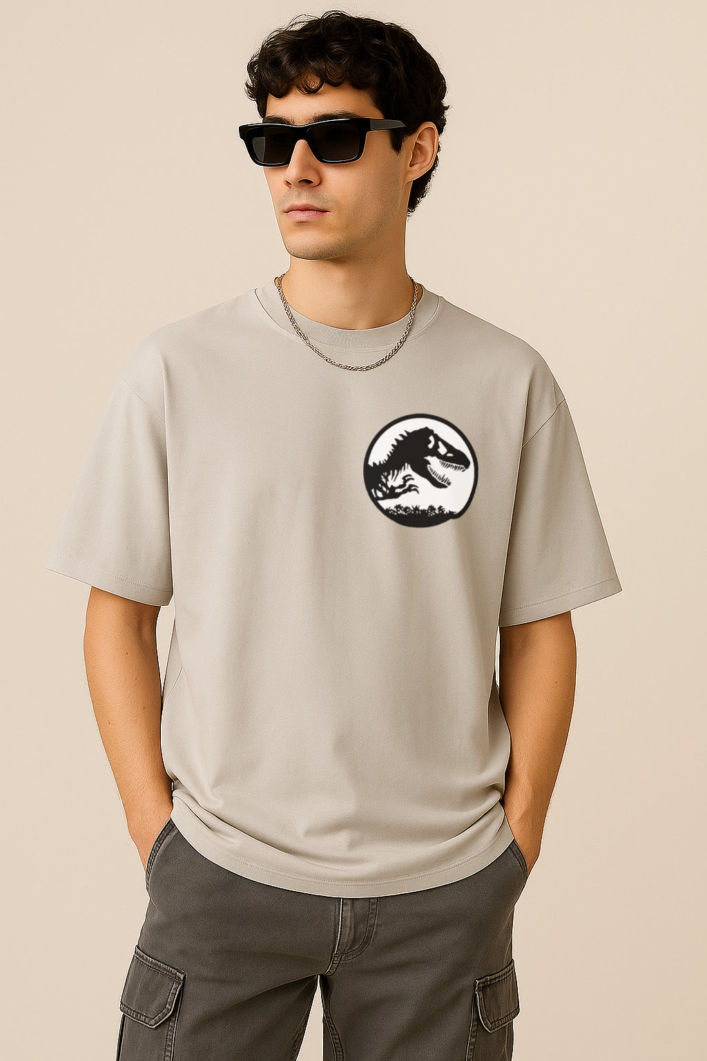 Front view showing dinosaur logo on grey oversized t shirt