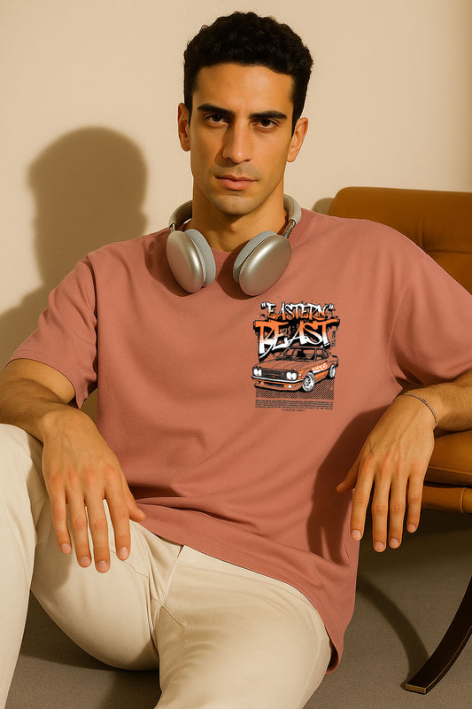 Seated model in pink oversized t shirt featuring street racing inspired front graphic and headphones