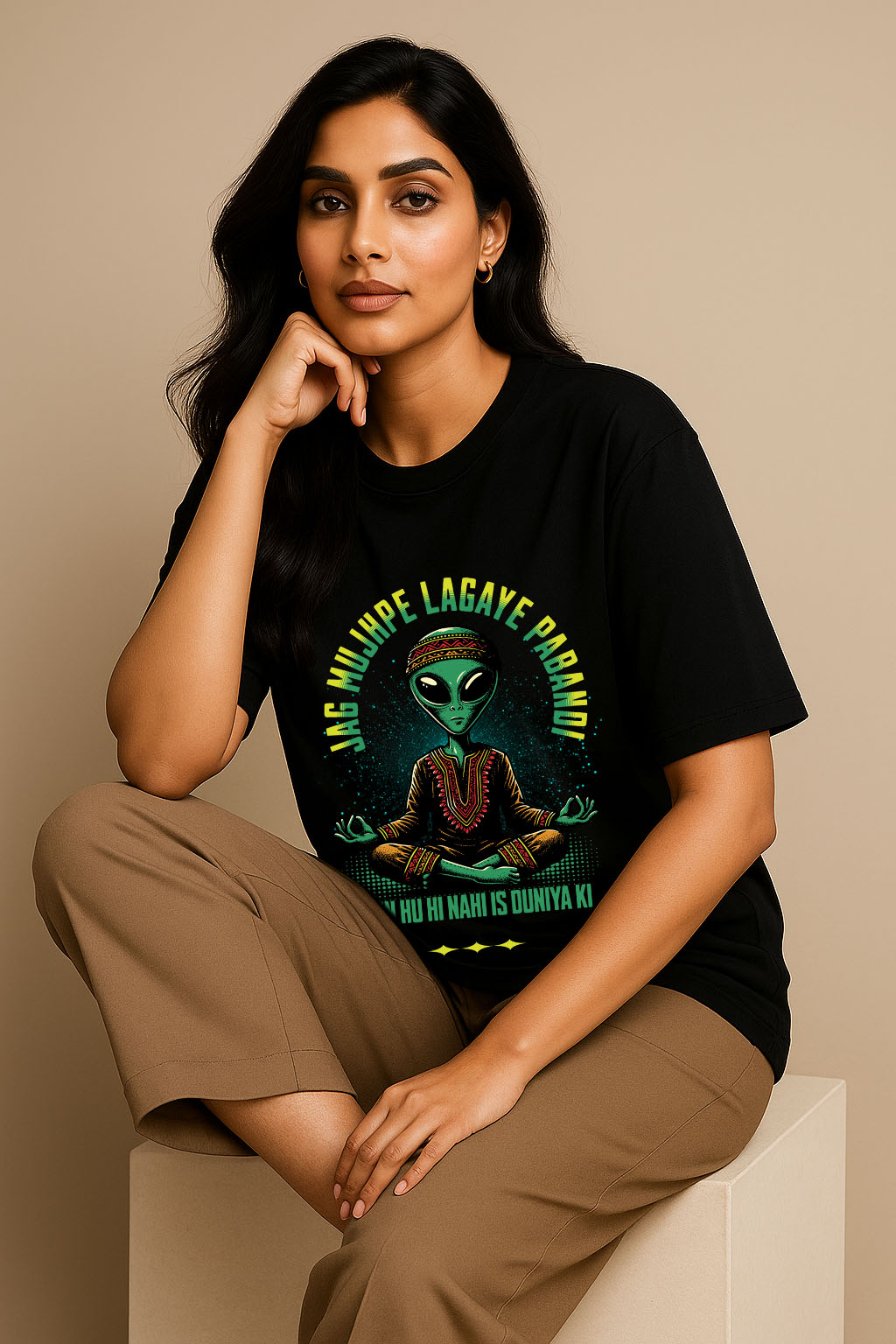 Relaxed pose of model in women's black oversized cotton t-shirt – desi alien graphic