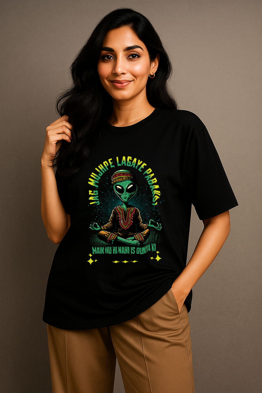 Seated model styling women's oversized black desi t-shirt with Hindi alien artwork