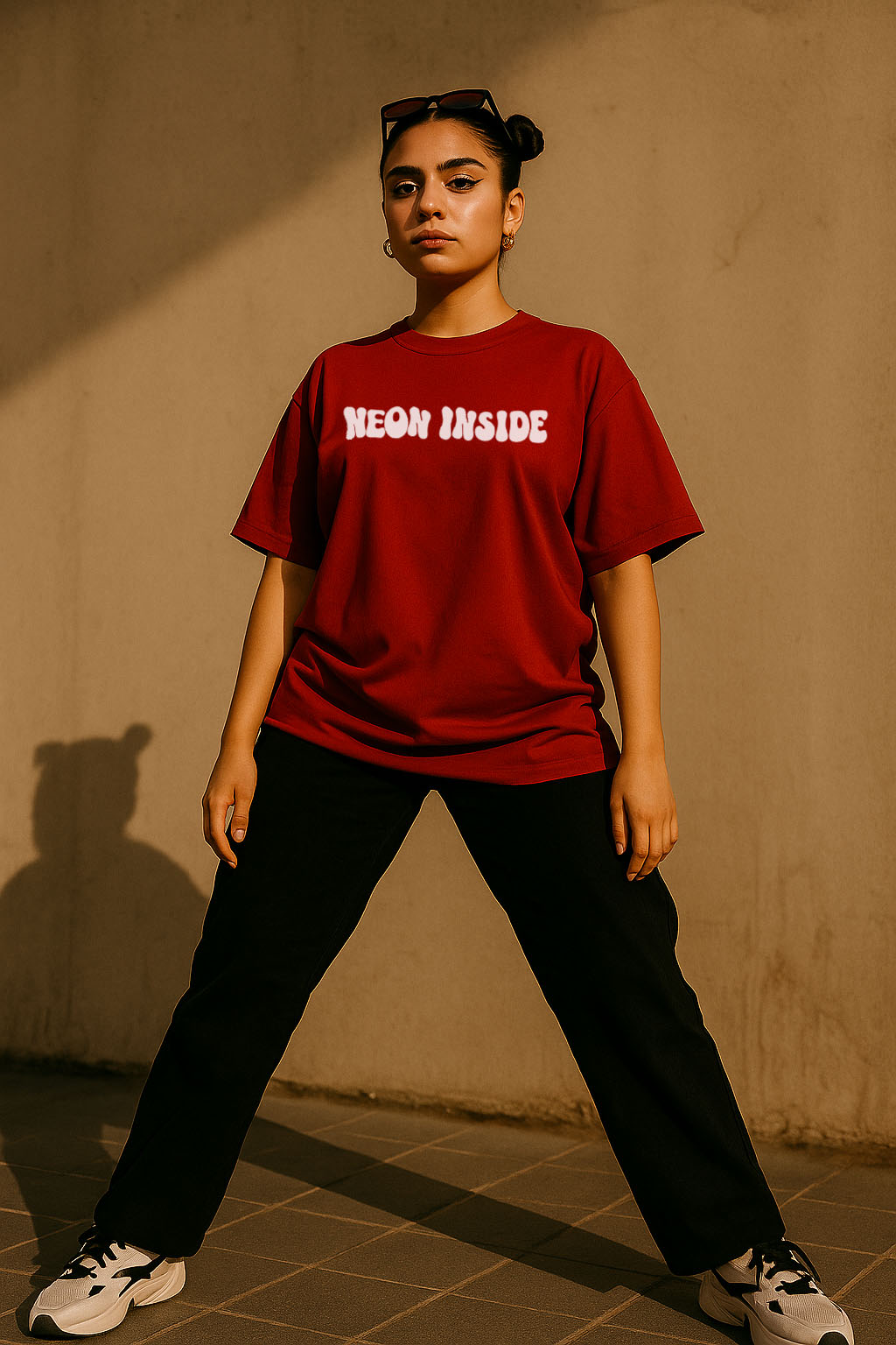 Bold pose of model wearing red "Neon Inside" oversized tee – premium cotton streetwear for women